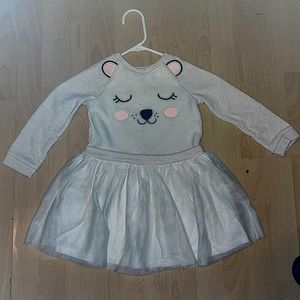 Four long sleeve shirts with ruffles at the end.